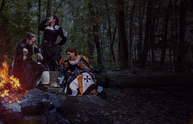 3 characters in Larp near of firecamp playing at chess and showing your guild heraldy for our custom service