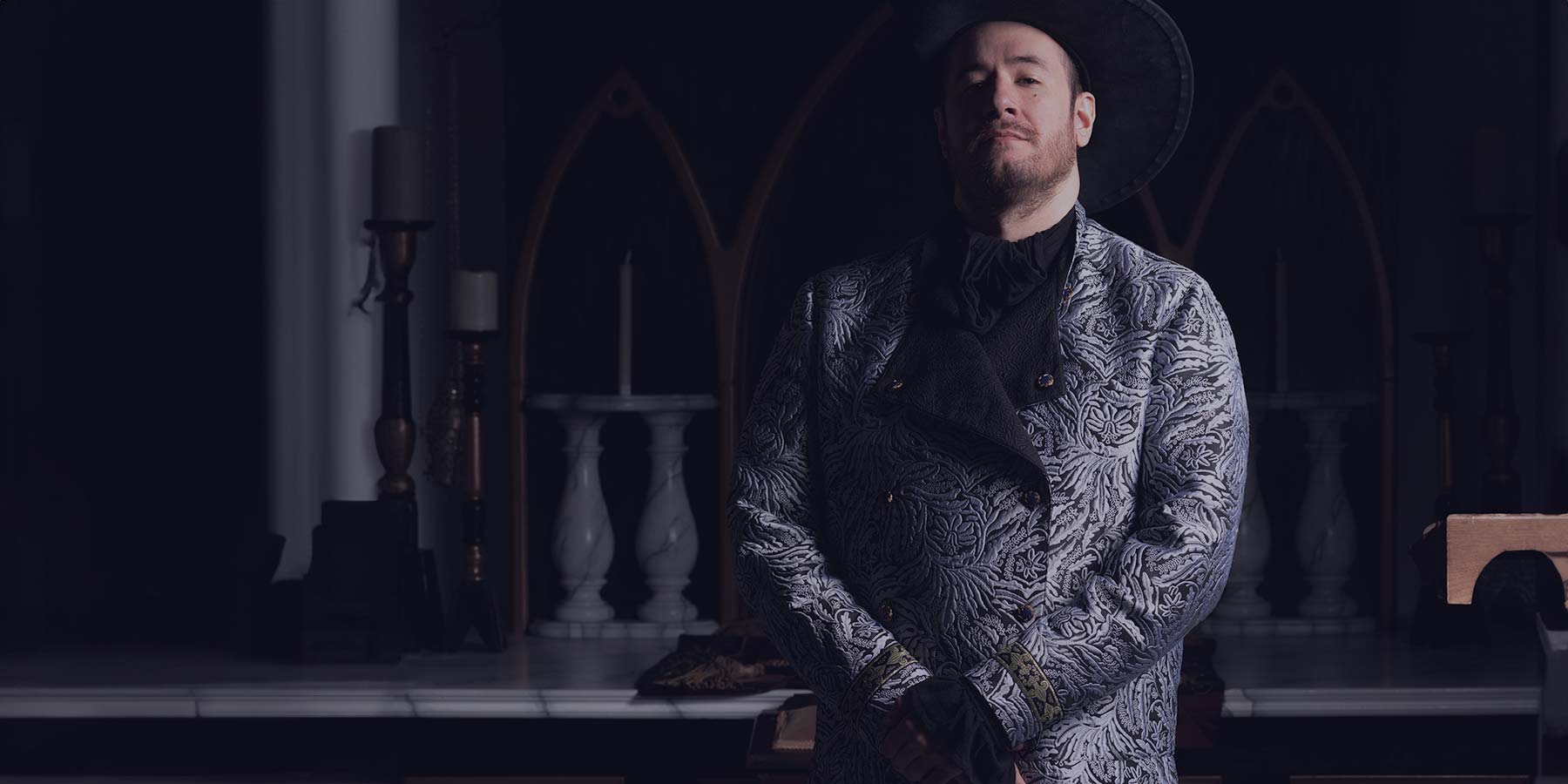 man with a custom larp coat in dark ambiance