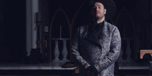 man with a custom larp coat in dark ambiance