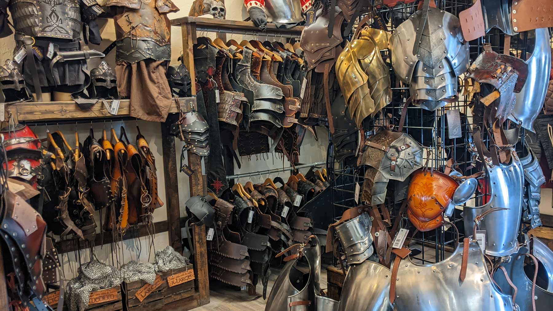 Photo of a section of our medieval store filled with leather and metal LARP armor.